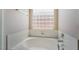 Close up of a soaking tub with a glass block window at 5586 Golden Leaf Ave, Las Vegas, NV 89122