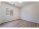 A bedroom featuring wood-like floors and neutral walls, complemented by natural light from a window at 5586 Golden Leaf Ave, Las Vegas, NV 89122
