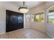 The dining area showcases tile flooring, a unique chandelier, and outdoor backyard views at 5586 Golden Leaf Ave, Las Vegas, NV 89122
