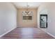 View of the dining room with wood floors, a chandelier, and a window showing the backyard at 5586 Golden Leaf Ave, Las Vegas, NV 89122