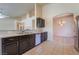 Kitchen featuring dark wood cabinets, granite countertops, and stainless steel appliances at 5586 Golden Leaf Ave, Las Vegas, NV 89122