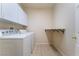 Laundry room equipped with washer, dryer, cabinets, and a folding table, offering convenience at 5586 Golden Leaf Ave, Las Vegas, NV 89122