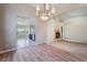 Bright and spacious living room featuring wood-look flooring, archways, and decorative chandelier at 5586 Golden Leaf Ave, Las Vegas, NV 89122