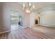 Bright and spacious living room featuring wood-look flooring, archways, and decorative chandelier at 5586 Golden Leaf Ave, Las Vegas, NV 89122