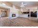 Open-concept living room featuring wood floors, fireplace, and seamless transition into kitchen at 5586 Golden Leaf Ave, Las Vegas, NV 89122