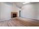 Bright living room featuring hardwood floors and a tile fireplace with views into the hallway at 5586 Golden Leaf Ave, Las Vegas, NV 89122