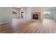 Spacious living room with hardwood floors, a cozy fireplace, and views into the kitchen and dining area at 5586 Golden Leaf Ave, Las Vegas, NV 89122