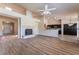 Open-concept living room featuring wood floors, fireplace, and seamless transition into kitchen at 5586 Golden Leaf Ave, Las Vegas, NV 89122