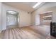 Bright open-plan living space with hardwood floors, arched doorways and a skylight providing natural light at 5586 Golden Leaf Ave, Las Vegas, NV 89122