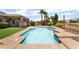 Backyard pool is surrounded by desert landscaping, grass, and fencing at 5586 Golden Leaf Ave, Las Vegas, NV 89122