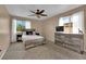 Bedroom with neutral tones, two windows, and a ceiling fan at 6108 Shallow Springs St, Las Vegas, NV 89130