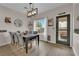 Cozy dining area with a modern light fixture and backyard view at 6108 Shallow Springs St, Las Vegas, NV 89130