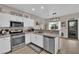 Eat-in kitchen featuring stainless steel appliances and modern lighting at 6108 Shallow Springs St, Las Vegas, NV 89130