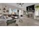 Cozy living room with a fireplace, large TV, gray sofa and lots of natural light at 6108 Shallow Springs St, Las Vegas, NV 89130