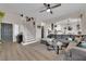 Open-concept living room with a staircase and wood flooring, perfect for entertaining at 6108 Shallow Springs St, Las Vegas, NV 89130
