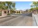 Gated entrance to a secure community, featuring stone pillars, lush landscaping, and a paved entry at 631 Coriander Canyon Ct, Las Vegas, NV 89138