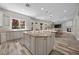 Spacious kitchen with an island, granite countertops, stainless steel appliances, and hardwood floors flowing into the dining area at 631 Coriander Canyon Ct, Las Vegas, NV 89138