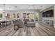 Bright living room with hardwood floors, modern chandelier, and large windows at 631 Coriander Canyon Ct, Las Vegas, NV 89138