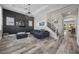 Spacious living room with hardwood floors, modern decor, and a staircase at 631 Coriander Canyon Ct, Las Vegas, NV 89138
