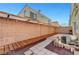 This backyard features a covered patio, brick perimeter, and a private outdoor space at 6320 Desert Leaf St # 101, North Las Vegas, NV 89081