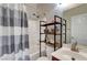 The bathroom features a shower-tub combo, a modern vanity, and industrial-style shelving at 6320 Desert Leaf St # 101, North Las Vegas, NV 89081