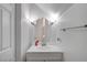 Bright half-bath with an oval mirror and modern vanity at 6320 Desert Leaf St # 101, North Las Vegas, NV 89081
