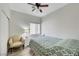 Bedroom with ceiling fan, a bright window and comfortable bed with patterned quilt at 6320 Desert Leaf St # 101, North Las Vegas, NV 89081