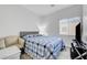 Bedroom featuring a comfy bed, neutral chair and bright window at 6320 Desert Leaf St # 101, North Las Vegas, NV 89081