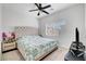 Inviting bedroom with a tufted headboard and a window at 6320 Desert Leaf St # 101, North Las Vegas, NV 89081