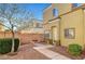 Home's front entrance with a brick wall and a small metal gate providing private access at 6320 Desert Leaf St # 101, North Las Vegas, NV 89081