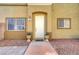 Up close front entrance showcasing a neutral exterior with a well-maintained walkway and potted plants at 6320 Desert Leaf St # 101, North Las Vegas, NV 89081