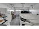 Organized garage with ample storage and a parked car at 6320 Desert Leaf St # 101, North Las Vegas, NV 89081