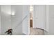 Stairwell featuring sleek white handrails and a partial view of a bathroom at 6320 Desert Leaf St # 101, North Las Vegas, NV 89081