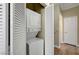 Hallway closet with stacked washer and dryer for convenient laundry at 6320 Desert Leaf St # 101, North Las Vegas, NV 89081