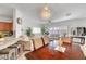 Open-concept living area featuring hardwood floors, a modern chandelier, seamlessly connecting living spaces at 6320 Desert Leaf St # 101, North Las Vegas, NV 89081