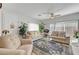 Inviting living room with plush seating, large windows, and a stylish area rug at 6320 Desert Leaf St # 101, North Las Vegas, NV 89081