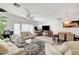 Bright living room featuring neutral decor, ceiling fan, chandelier, and modern furnishings at 6320 Desert Leaf St # 101, North Las Vegas, NV 89081