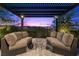 A beautifully designed pergola-covered patio with comfortable seating offers a tranquil backyard retreat at 6338 Skystone St, Las Vegas, NV 89135