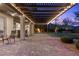 Spacious backyard patio with a pergola, string lights, and ample seating for outdoor entertaining at 6338 Skystone St, Las Vegas, NV 89135