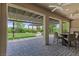 The backyard patio is an inviting outdoor space with a pergola, fireplace, and manicured landscaping for relaxation at 6338 Skystone St, Las Vegas, NV 89135
