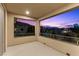 Balcony with twilight views of the city and surrounding hills, showcasing a tranquil outdoor space at 6338 Skystone St, Las Vegas, NV 89135