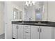 Well-lit bathroom featuring dual sinks, gray countertops, and sleek white cabinetry at 6338 Skystone St, Las Vegas, NV 89135