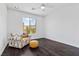 Bright bedroom boasts dark hardwood floors, a large window with mountain views, and stylish seating at 6338 Skystone St, Las Vegas, NV 89135