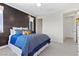 Inviting bedroom with modern accent wall, plush bedding, and bright natural light at 6338 Skystone St, Las Vegas, NV 89135