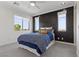 Inviting bedroom with modern accent wall, plush bedding, and bright natural light at 6338 Skystone St, Las Vegas, NV 89135