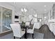 Bright dining area with a modern chandelier, leading to the kitchen and living spaces at 6338 Skystone St, Las Vegas, NV 89135