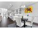 Bright dining area with a modern chandelier, leading to the kitchen and living spaces at 6338 Skystone St, Las Vegas, NV 89135