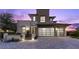 Modern two-story home with a stylish garage door and well-manicured landscaping showcasing contemporary design at 6338 Skystone St, Las Vegas, NV 89135