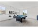 Entertainment room with a pool table, bar seating, and ample natural light from large windows at 6338 Skystone St, Las Vegas, NV 89135