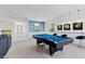 Bright game room with a pool table, bar-style seating, blue tiled backsplash, and modern decor for entertaining at 6338 Skystone St, Las Vegas, NV 89135